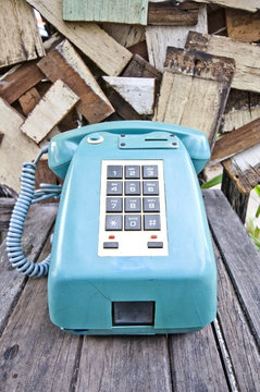 Blue Vintage telephone on old wood table
