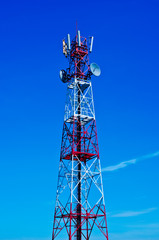 Telecommunications tower, painted white and red in a day of clea