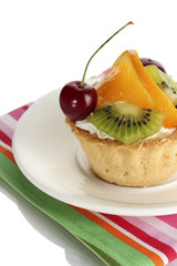 sweet cake with fruits on plate isolated on white
