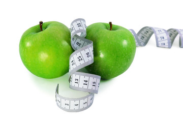Green apples with  measurement tape  on a white background