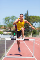 Obraz premium Male Track and Field Athlete during Obstacle Race