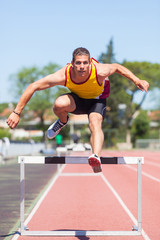 Fototapeta premium Male Track and Field Athlete during Obstacle Race