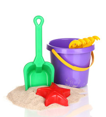 Children's beach toys and sand isolated on white