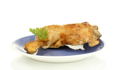 roasted chicken leg with parsley in the plate isolated on white
