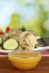 delicious dumpling dipped in sauce close-up