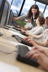 Student & Teacher Using Computers at College © spotmatikphoto