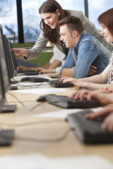 Student & Teacher Using Computers at College