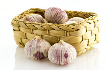 small violet garlic in straw basket