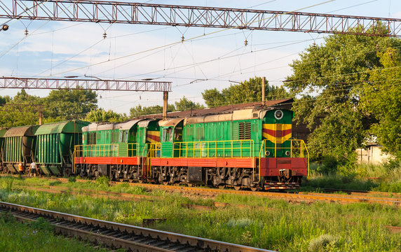 Two shunters with freight train at a station