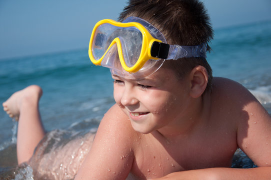 Boy at sea with a mask for snorkeling