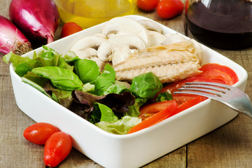 healthy salad with ingredients on wood