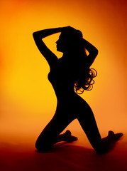 Fototapeta na wymiar woman sexy silhouette over orange background