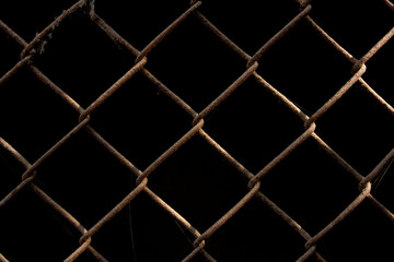 Fototapeta premium rusty metal grid on a black background
