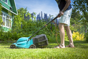 Man mowing the lawn in the yard