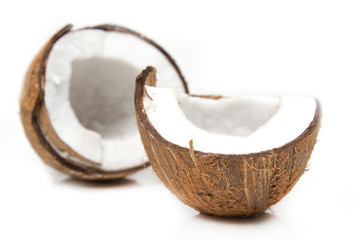 Closeup of cracked coconut on white background with light shadow
