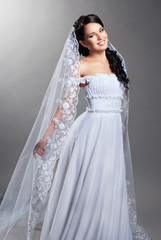 beautiful bride is standing in wedding dress