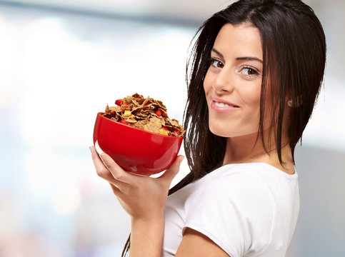 portrait of young woman holding a cereal bowl indoor