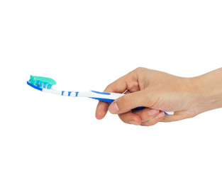 Toothbrush and toothpaste in a hand