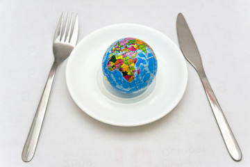 Consumerism concept - the Earth on a plate