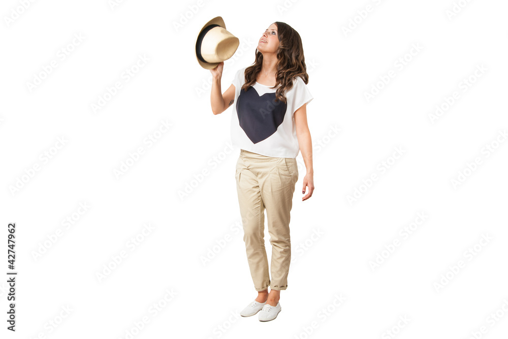 Wall mural young fashionable brunette throwing a stylish hat