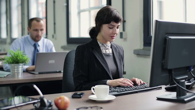 Young attractive businesswoman working on computer