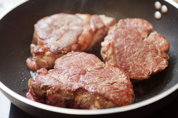 beef steak in a frying pan