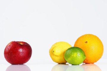 Apple compared to citrus fruits over white