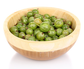 Green gooseberry in wooden bowl isolated on white