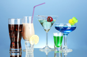 a variety of alcoholic drinks on blue background