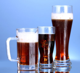 refreshments - beer, cola and kvass on blue background