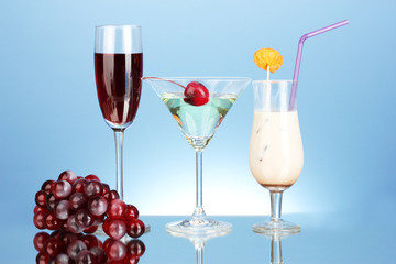 a variety of alcoholic drinks on blue background