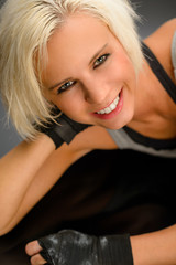 Fototapeta premium Female kickboxer in black relax lying down