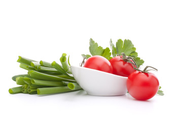 Spring onions and cherry tomato in bowl