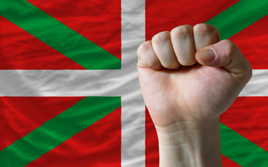Hard fist in front of basque flag symbolizing power