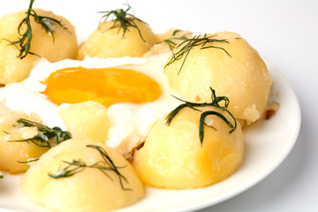 Young potatoes with fried eggs