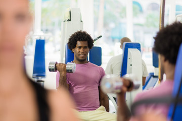young people training and working out in fitness club