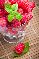 Sweet fresh raspberry fruits in glass goblet