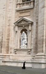 Obraz premium Walking nun in front of huge Vatican basilica with a big marble sculpture, Vatican City, Europe