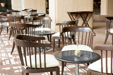 Interior of modern restaurant with the covered tables