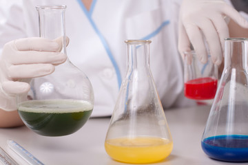 Woman examine colorful bottles fill with chemicals