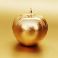gold apple on gold background