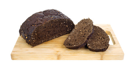 Sliced black rye bread on cutting board