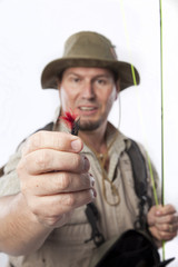 Fototapeta premium Fly fisherman holding out his favourite bait.