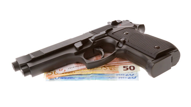Semi-automatic gun with some euro bills isolated