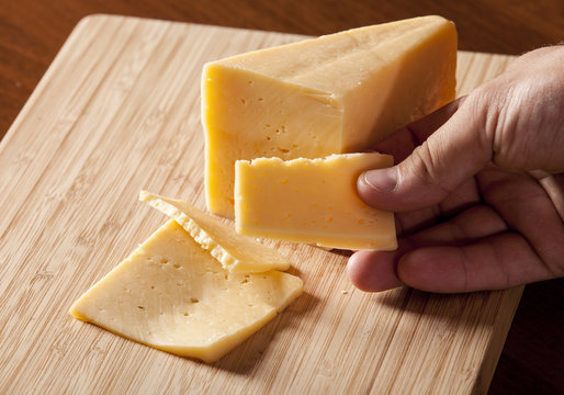 Man holding piece of cheese