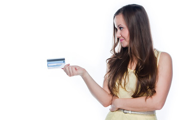 Young and beautiful girl with a credit card in the hands of blue