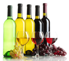 bottles and glasses of wine and ripe grapes isolated on white
