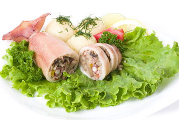 Squid stuffed with shrimp and vegetables on salad leaf
