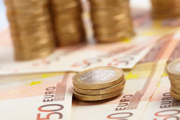 Euro coins on banknote money background