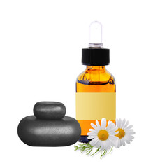 black spa stones, bottle with essence oil and chamomile flowers